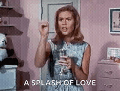 Woman In Blue Dress Holding Wine GIF