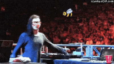 Woman In Blue Dress In Front Of Crowd With Bee GIF