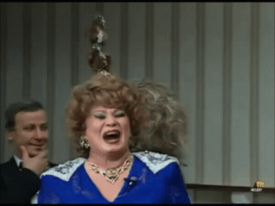 Woman In Blue Dress Laughing While Man Looks On GIF
