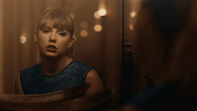 Woman In Blue Dress Looking In Mirror GIF