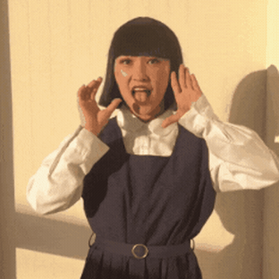 Woman In Blue Dress Making Funny Face GIF