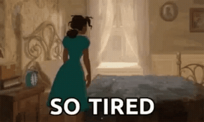 Woman In Blue Dress Next To Bed GIF