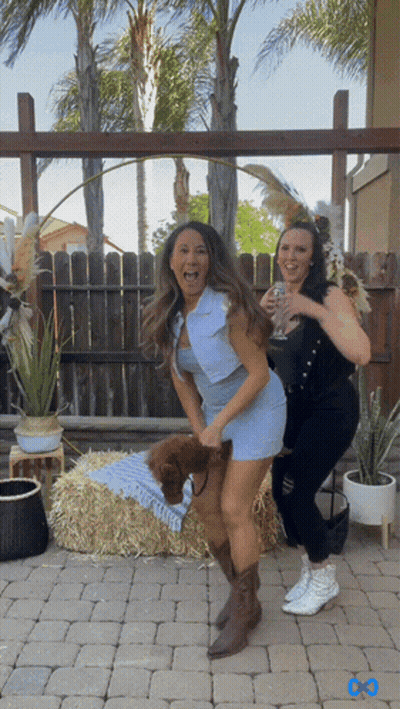 Woman In Blue Dress Next To Woman In Black Dress GIF