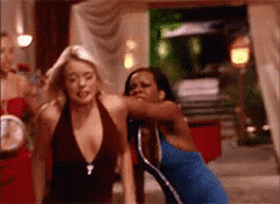 Woman In Blue Dress Next To Woman In Brown Top GIF