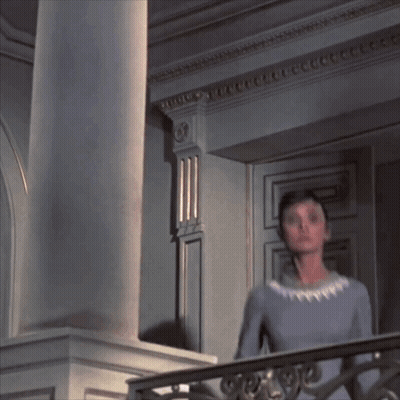Woman In Blue Dress On Balcony With Columns GIF