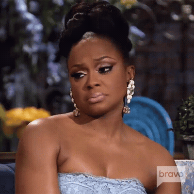 Woman In Blue Dress On Couch With Bravo GIF