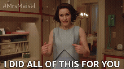 Woman In Blue Dress Pointing At Herself GIF
