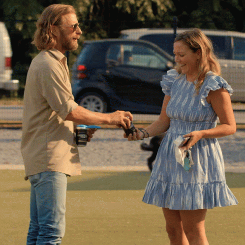 Woman In Blue Dress Shaking Hands With Man In Beige Shirt GIF