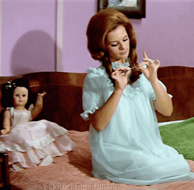 Woman In Blue Dress Sits On Bed Next To Doll Eskiturkfilmi.tumblr GIF