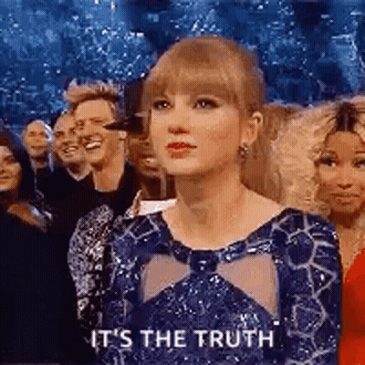 Woman In Blue Dress Sitting Before Crowd GIF