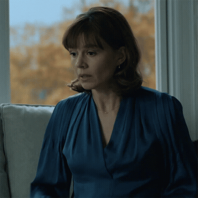 Woman In Blue Dress Sitting On Couch GIF