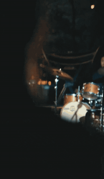 Woman In Blue Dress Sitting On Stool GIF