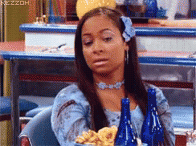 Woman In Blue Dress Sitting With Blue Bottles And French Fries GIF