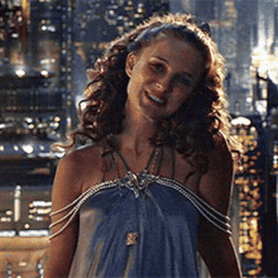 Woman In Blue Dress Smiling At Night City GIF