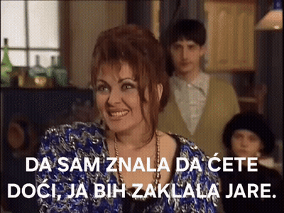 Woman In Blue Dress Smiling With Man In Suit GIF