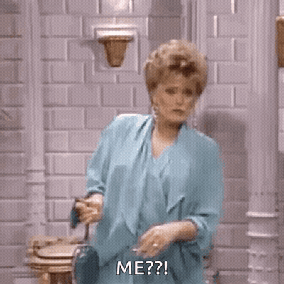 Woman In Blue Dress Smoking Cigarette By Brick Wall GIF