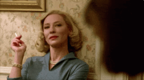 Woman In Blue Dress Smoking Cigarette GIF