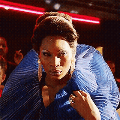 Woman In Blue Dress Standing Before Crowd GIF