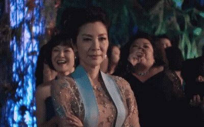 Woman In Blue Dress Standing In Crowd GIF