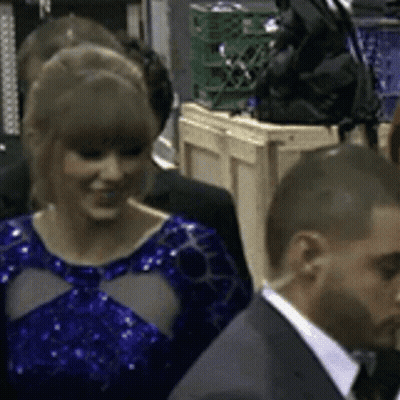 Woman In Blue Dress Standing In Crowd GIF