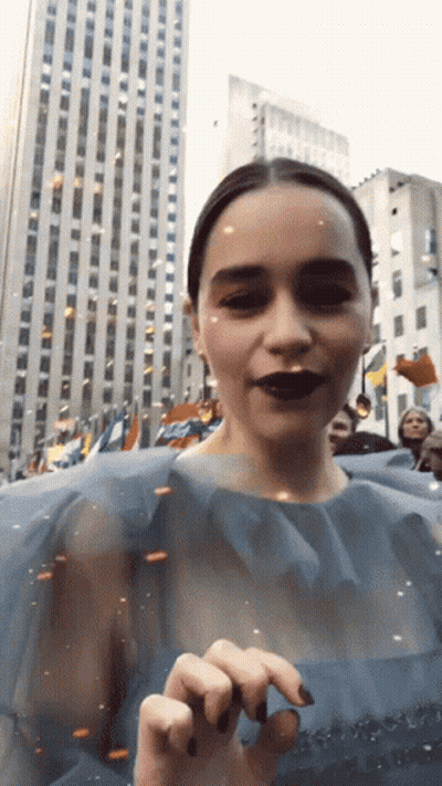 Woman In Blue Dress Standing In Front Of Building GIF