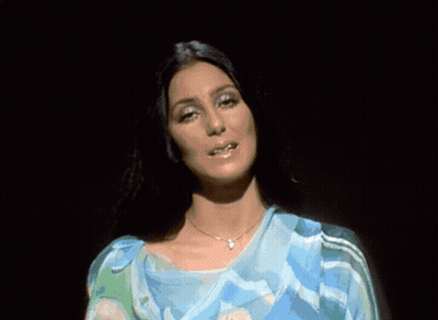 Woman In Blue Dress Standing In Front Of Crowd GIF