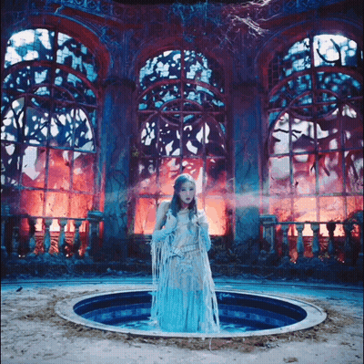 Woman In Blue Dress Standing In Pool GIF