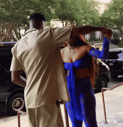 Woman In Blue Dress Standing Next To Man GIF