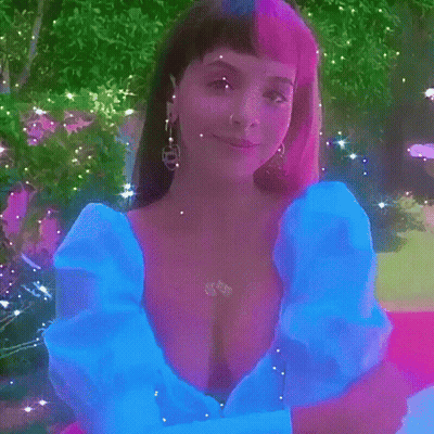 Woman In Blue Dress Standing On Pink Carpet In Park GIF