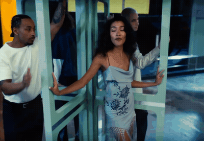 Woman In Blue Dress Surrounded By People GIF
