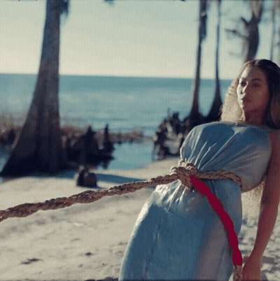 Woman In Blue Dress Tied With Rope GIF