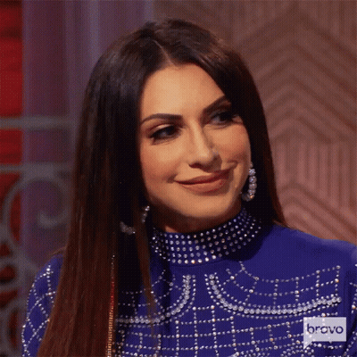 Woman In Blue Dress With Bravo Logo GIF