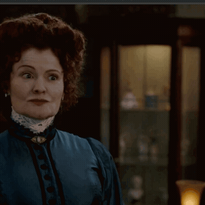 Woman In Blue Dress With Brooch GIF