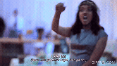 Woman In Blue Dress With Flower Crown Saying La Ha Ha GIF