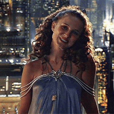 Woman In Blue Dress With Pearl Sleeves Smiling GIF