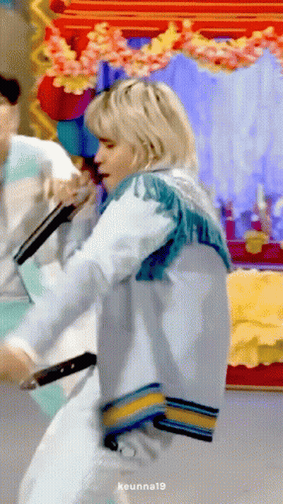 Woman In Blue Fringed Jacket Holding Microphone And Dancing GIF
