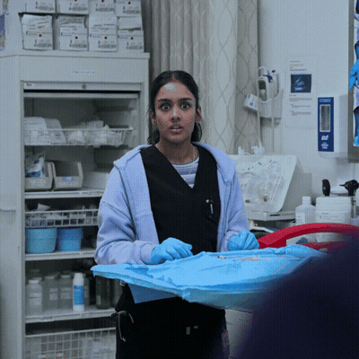 Woman In Blue Gloves Standing By Refrigerator GIF