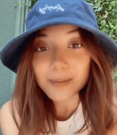 Woman In Blue Hat And White Shirt Smiling GIF
