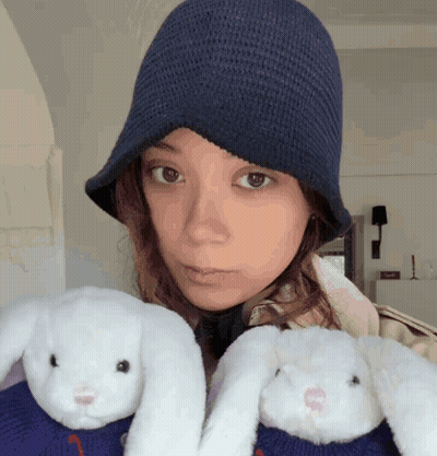 Woman In Blue Hat Holding Two Stuffed Animals GIF