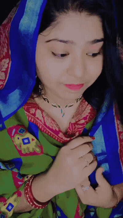 Woman In Blue Head Scarf And Green And Pink Dress GIF