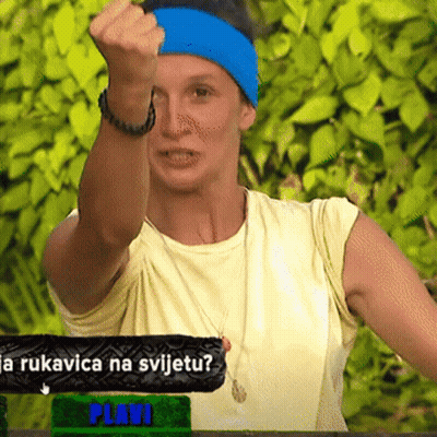 Woman In Blue Headband Holding Fist Up In Front Of Plavi Sign GIF