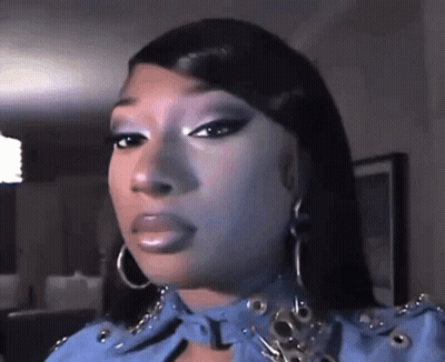 Woman In Blue Jacket And Hoop Earrings GIF