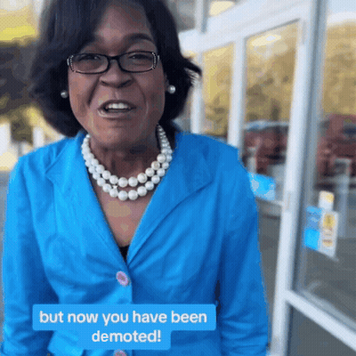 Woman In Blue Jacket And Pearls Says But Now You Have Been Demoted GIF