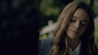 Woman In Blue Jacket And White Shirt Looking Down GIF