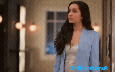 Woman In Blue Jacket At Window With Twitter Logo GIF