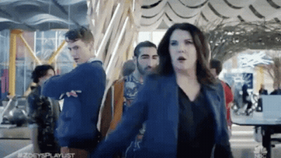Woman In Blue Jacket Dancing Before Crowd GIF