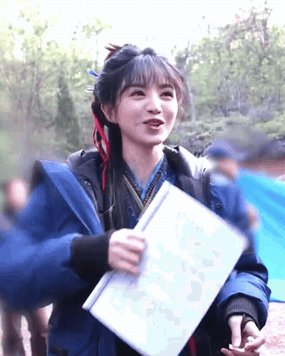 Woman In Blue Jacket Holding Paper GIF