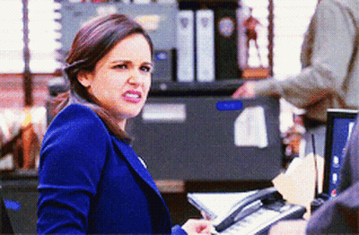 Woman In Blue Jacket Holding Phone GIF
