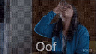 Woman In Blue Jacket Holding Water Glass GIF