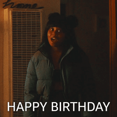 Woman In Blue Jacket In Front Of Home Sign GIF